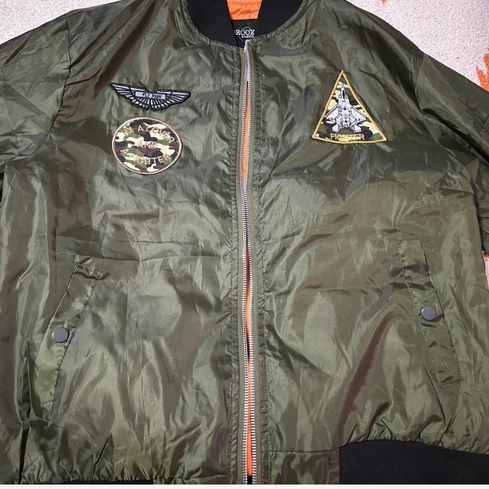 Green and black bomber jacket with a streetwear vibe